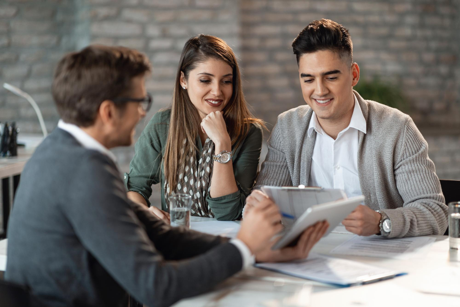 young-happy-couple-having-consultations-with-bank-manager-meeting-office